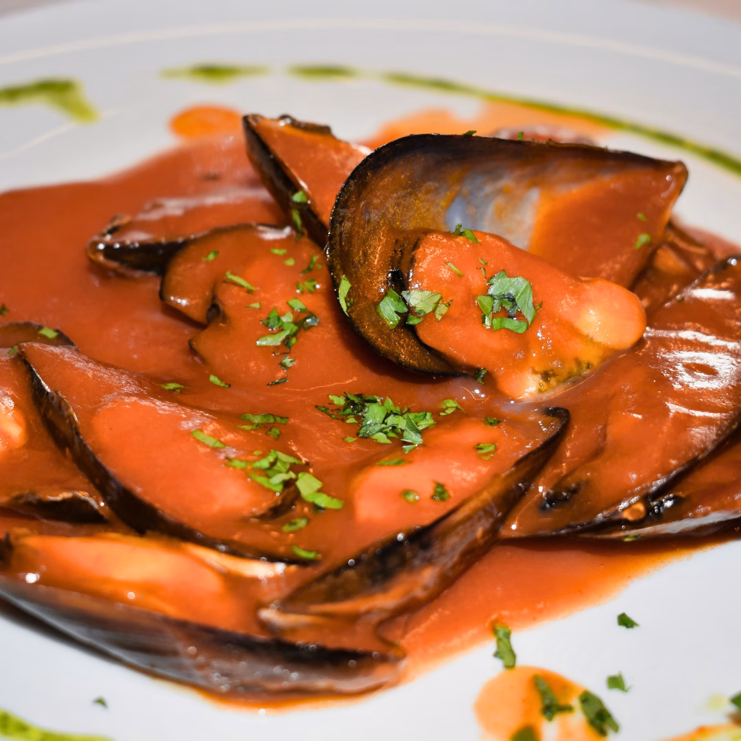 Traditional La Spezia stuffed mussels served in tomato sauce
