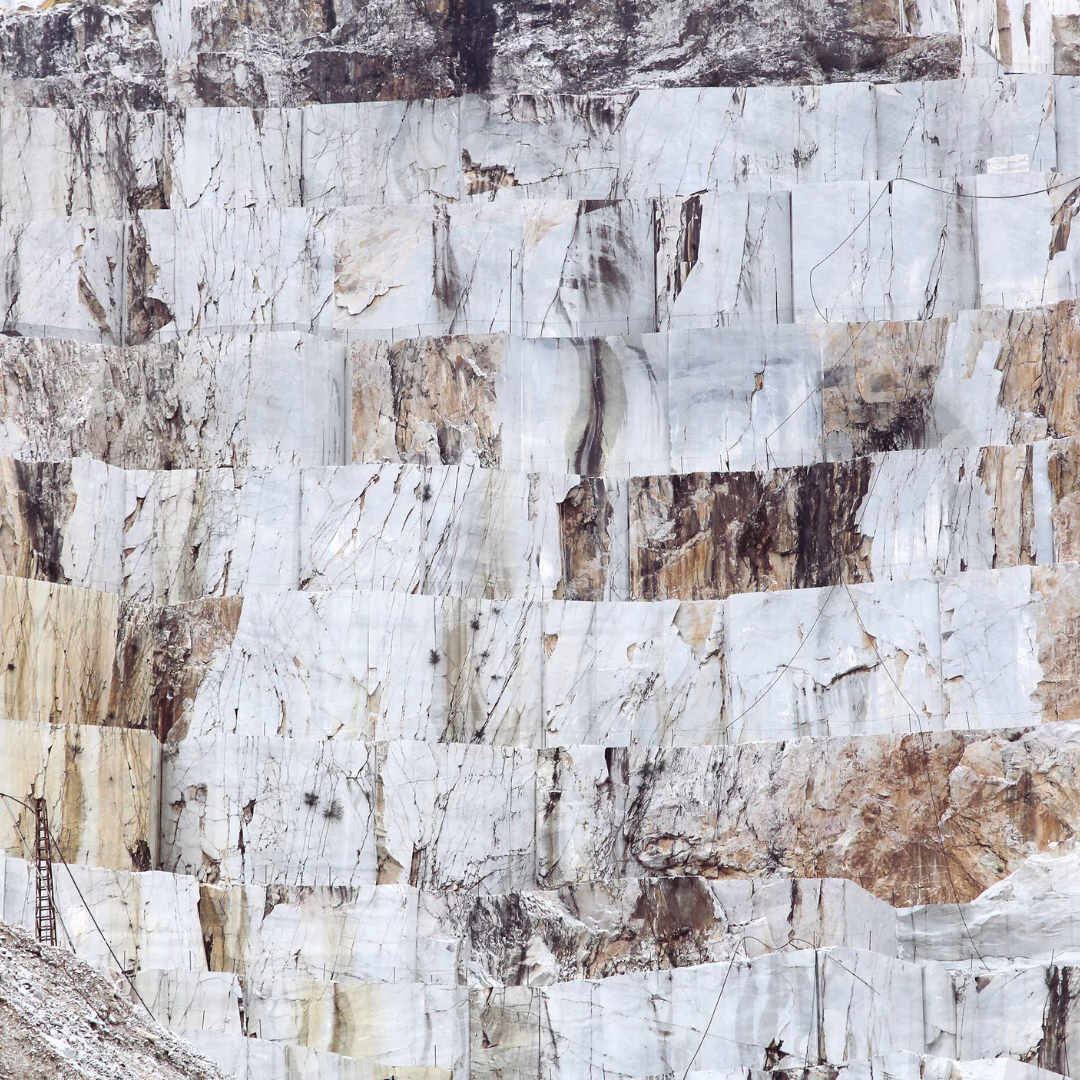 White marble walls of the Carrara quarries rising against the Apuan Alps